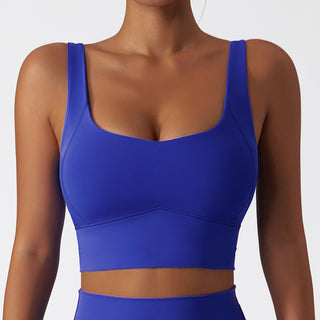 Blue sports bra with a scooped neckline and wide shoulder straps. The bra has a sheer, lightweight design and is suitable for various fitness activities like yoga or running.