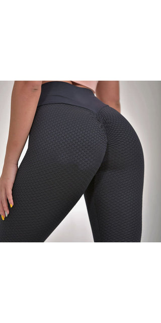 Textured black fitness leggings with high waistband for women's active lifestyle.
