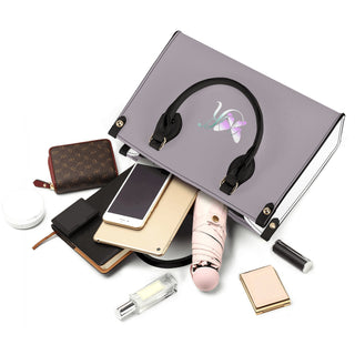 Silver shiny vanity case showcasing various women's accessories including a headphone, smartphone, makeup case, lipstick, and other cosmetic items, arranged in a stylish composition against a white background.