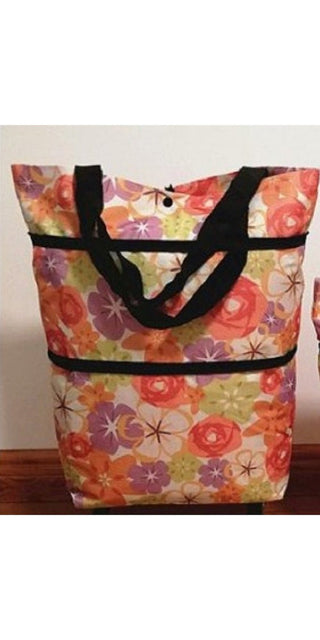 Vibrant floral patterned shopping tote bag with sturdy black handles and zipper closure, ideal for carrying essentials during shopping trips or everyday use.