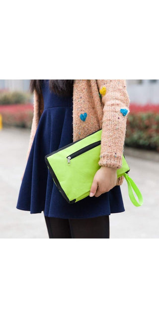 Fashionable woman's outfit with colorful knit cardigan and neon green clutch