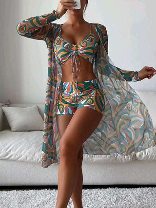 Colorful printed bikini with matching long sleeve cardigan, fashionable beach attire for summer.