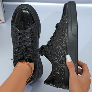 Glittering black sneakers with thick soles and lace-up design, showcasing a fashionable and trendy footwear option.