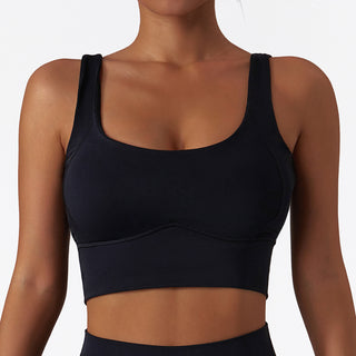 Black sports bra with scoop neckline and seamless design for a comfortable, supportive workout.