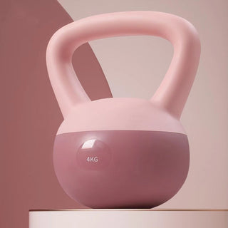 Pink exercise kettlebell with 4KG weight marking on a minimalist white shelf