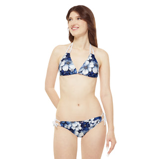Floral bikini set with halter top and strappy bottoms on smiling young woman