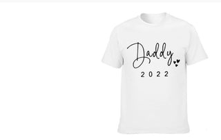 Matching white t-shirts for father and child, featuring the text "Daddy 2022" and a paw print design, showcasing coordinating family style.