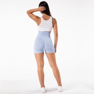 Stylish, comfortable women's yoga shorts in a light blue color, worn by a female model with long dark hair. The shorts feature a high-waist design for a flattering fit.