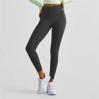 Stylish fitness leggings from K-AROLE: Sleek black design for an active lifestyle, complemented by sporty white sneakers.