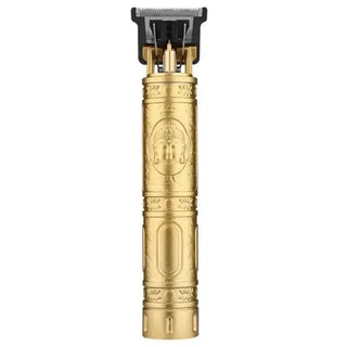 Gold-colored vintage electric hair trimmer with ornate design