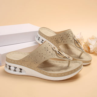 Trendy perforated beige wedge thong sandals with a chunky platform sole for a comfortable and stylish summer look.