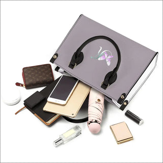 Silver shiny vanity case showcasing various women's accessories including a headphone, smartphone, makeup case, lipstick, and other cosmetic items, arranged in a stylish composition against a white background.