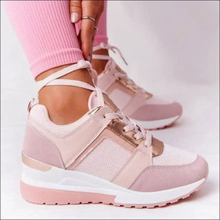 Stylish women's sneakers with chunky soles, a mix of pastel pink and white materials, and trendy lace-up design for a fashionable and comfortable athleisure look.