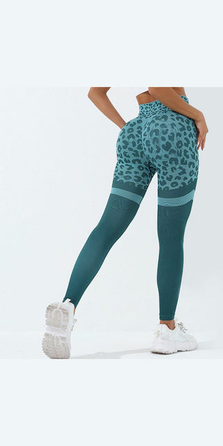 Leopard print high-waist seamless leggings in teal and green colors on a model standing against a white background, showcasing a stylish and trendy athletic look.