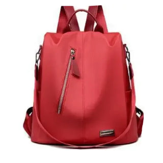 Stylish red backpack with zipper detail, perfect for school or everyday use.