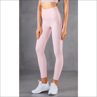 High-waisted peach-colored athletic leggings with a slim, body-hugging fit, designed for a comfortable and confident workout experience. Paired with white sneakers, this outfit showcases a modern, stylish activewear look.