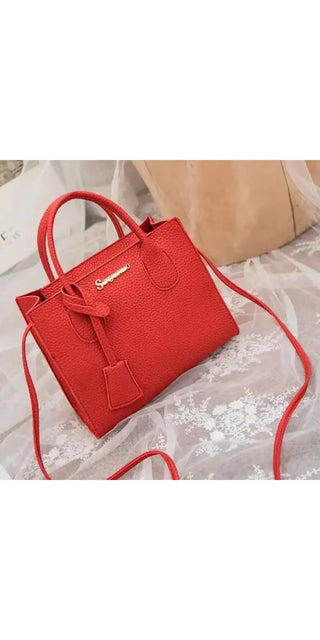 Fashionable red leather handbag with metal hardware and shoulder strap, featuring a sleek and contemporary design.