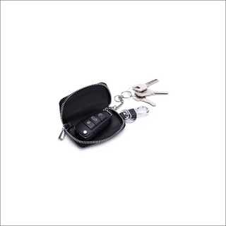 Leather key holder with zipper, featuring a compact design to organize and protect car keys and accessories. Sleek black finish with a metallic keychain for easy access.