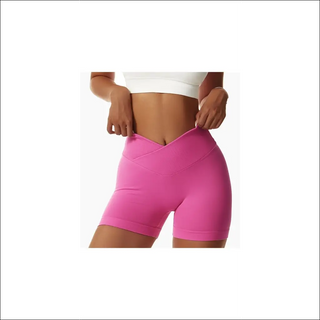 Tight seamless pink sports shorts for women, worn by a female model against a white background.