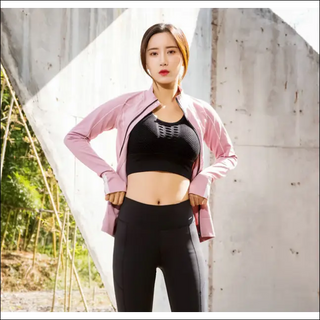 Slim-fit sportswear with stylish pink jacket, black crop top, and sleek leggings - versatile athletic attire for modern women.