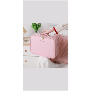 Stylish pink travel makeup bag with ample storage space, perfect for organized cosmetics on-the-go.