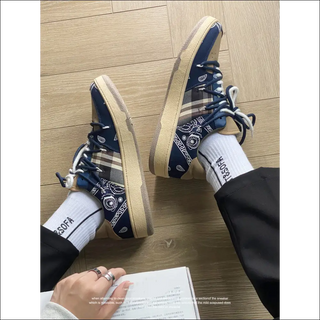 Stylish navy and white printed fitness sneakers on wooden floor