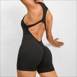 Sleek black yoga fitness jumpsuit with back cutout detail, showcasing toned physique