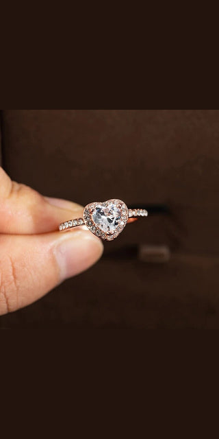 Stunning crystal heart-shaped wedding ring for women, featuring a rose gold design and elegant jewelry accents, perfect for an engagement or special occasion.