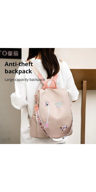 Waterproof embroidered oxford women's travel backpack with anti-theft features, showcased in a studio setting.