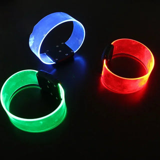 Vibrant LED silicone bracelets in blue, green, and red colors with flashing lights, perfect for parties and events.