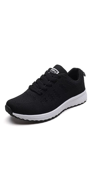 Stylish women's casual sneakers in sleek black and white design. Breathable mesh upper provides comfort and flexibility. Durable rubber sole offers traction for daily walking. Fashionable yet practical footwear for an active lifestyle.