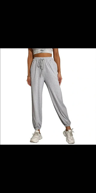 Casual style long pants for women and men, featuring a comfortable, relaxed fit and a drawstring waistband for adjustability. The pants are displayed against a dark background, showcasing their simple and versatile design.