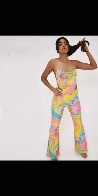 Colorful printed sleeveless long jumpsuit, stylish woman posing against white backdrop.