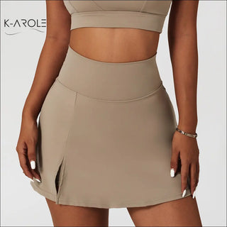 Ribbed one-shoulder yoga bra and high-waisted sports skirt in neutral tone, showcasing a modern, athletic fashion look from the K-AROLE brand.